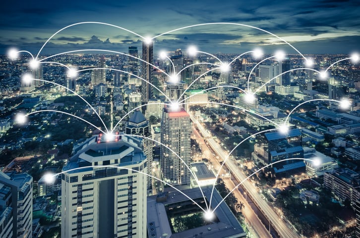 The picture of a city where buildings are interconnected nodes in a vast network.