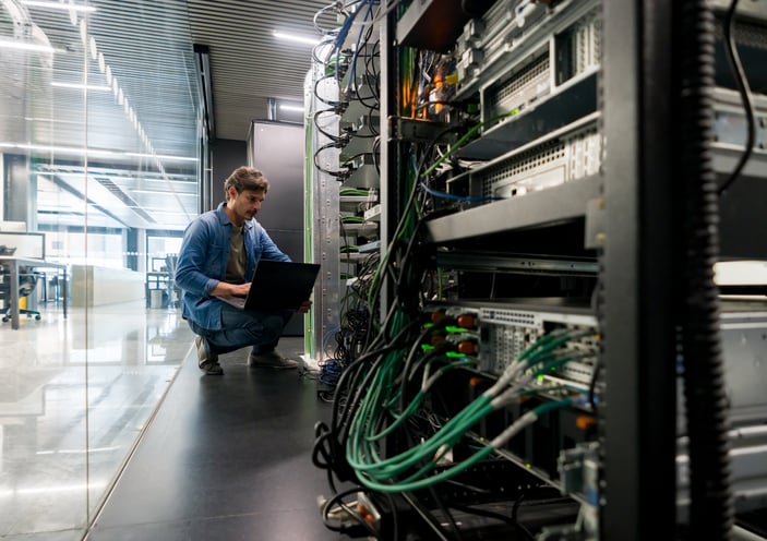 A technician checks an on-premises computer server.