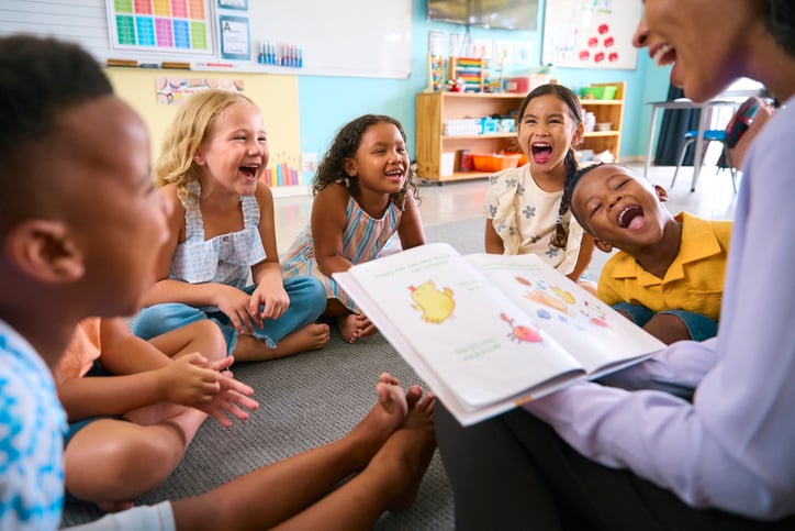 Image of a teacher reading a story to children