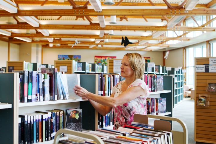 Librarian shelving books
