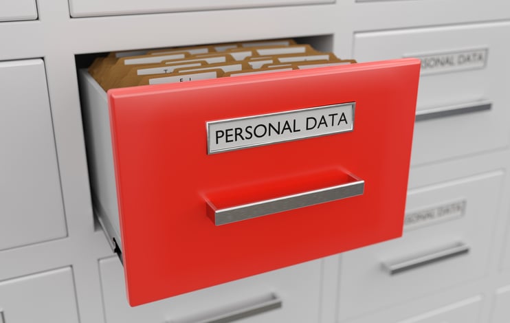 Image of a filing cabinet with a red draw containing personal data