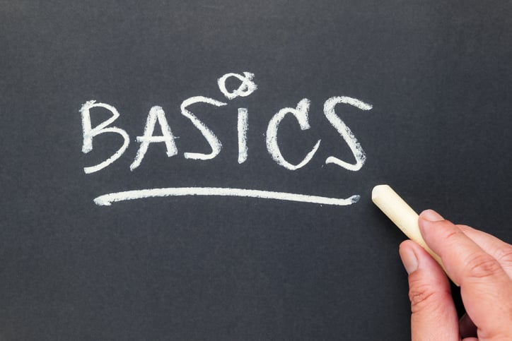 The word "basics" written in chalk